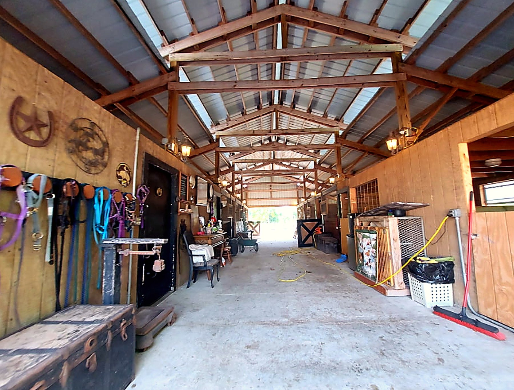 Warm barn aisle with animal care supplies and stalls